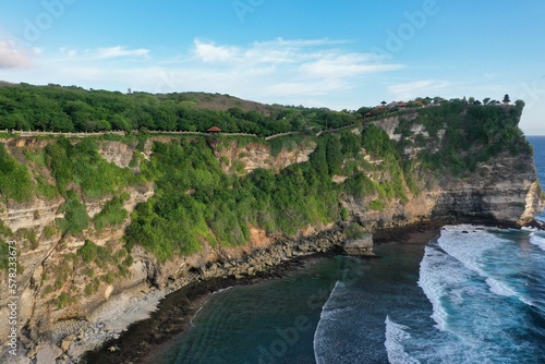 Panorama shot of the spectacular temple complex Pura Luhur in Uluwau on Bali  along the majestic  green-covered cliffs that flow into the sea.