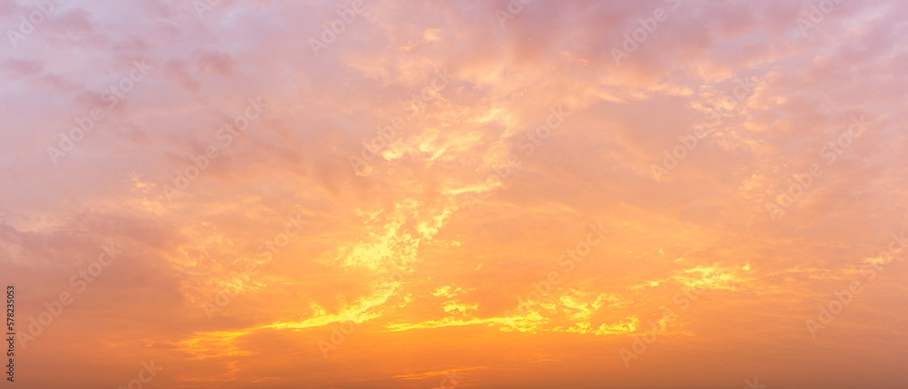 Photo of the morning sky, soft clouds covered the sky, panoramic image, orange tones, natural phenomenon background.