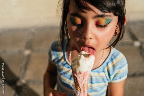 Girl eating an ice cream in the street.