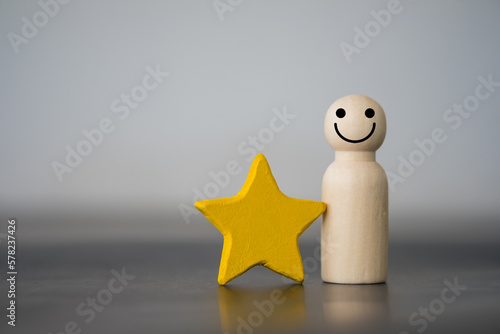 Wooden figures peg doll standing together with a yellow star. Talent, Human resources. Stand out from the crowd. Different and individual unique person. Spotlight shining to the best person