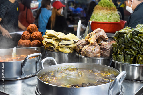 Many vietnamese snacks with boild and fried meat and soup in vietnamese night market in Da Lat