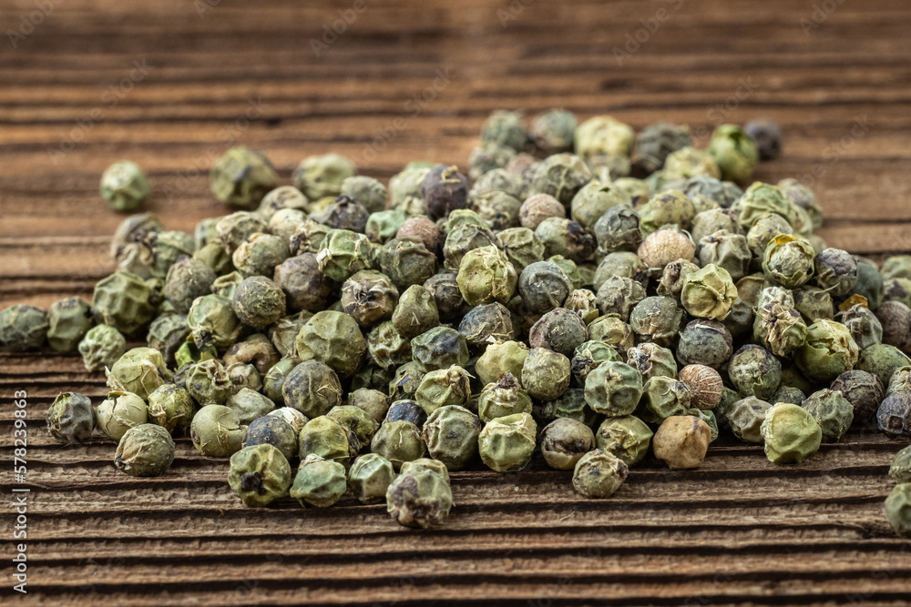 Dried spices green pepper on a wooden board Dried spices green pepper on a wooden board
