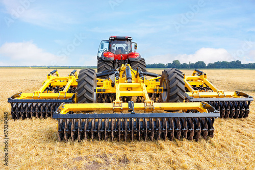 Obraz na plátne Toothed metal multi-row yellow harrow as a tractor hitch for agricultural processing of fields