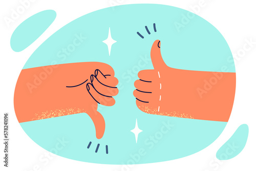 Two hands showing thumbs up or down symbolizes argument on current topic or difficult choice