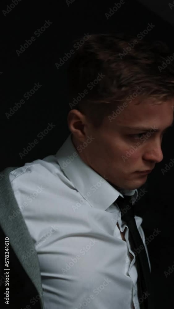 A man putting on a jacket and getting ready for a wedding