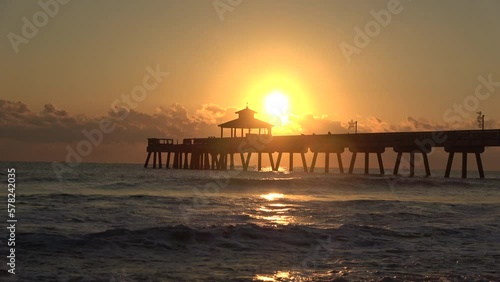 Close up sunrise sunset at pier  by the ocean and beach photo