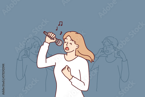 Woman sings in karaoke standing near friends covering ears due to unbearable voice or high volume. Girl suffering from stress performs songs in Karaoke, preventing people around from relaxing
