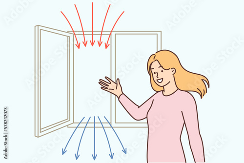 Woman points to open window recommending regular airing of apartment for air recirculation