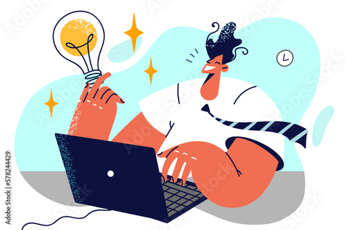 Man with laptop holds giant light bulb symbolizing innovative idea for business development