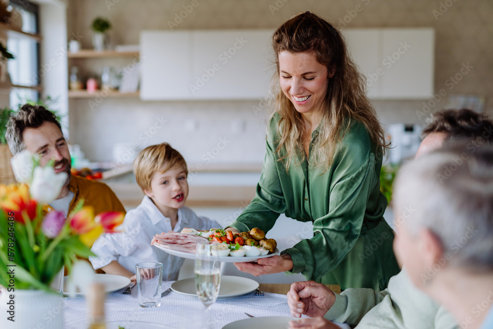 © Halfpoint - Happy multigenertional family having Easter dinner together. © Halfpoint - Happy multigenertional family having Easter dinner together.
