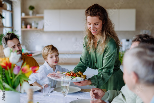 Photography Happy multigenertional family having Easter dinner together.
