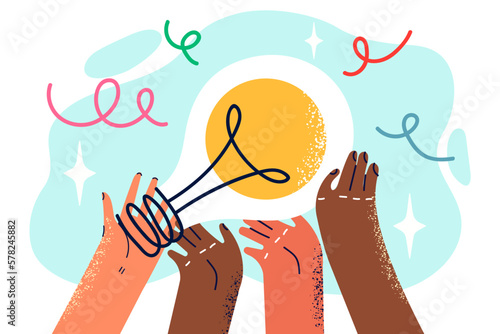 Peoples hands with light bulb symbolizing joint generation of ideas and solutions
