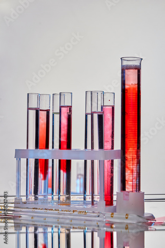 Set of lab test tubes with samples of blood. Vertical shot white background. © DenisProduction.com