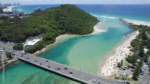 Traffic At The Tallebudgera Creek Bridge Spanning Turquoise Waters In Burleigh Heads, Queensland, Australia. aerial photo