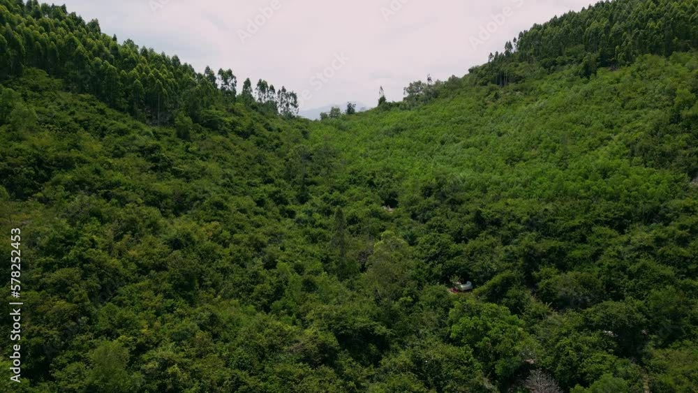 Aerial view of Nha Trang and scenic wooded mountains around the city, Vietnam. Drone flying over the coastal city and amazing green hills.Vietnam. View from mountain Nui Co Tien. 4K