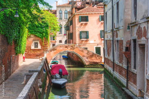 Venice, Italy. Beautiful view on Venetian canal with old colorful buildings and bridge over channel in Venezia