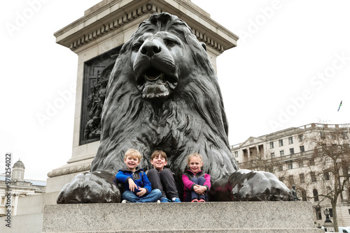 Three Smiling Siblings Sit on the Trafalgar Square Lion