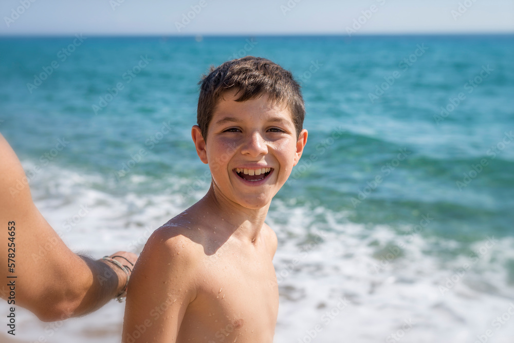 Portrait of young standing at seashore while smiling in a sunny day Portrait of young standing at seashore while smiling in a sunny day
