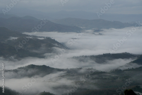 Landscape Green nature fog and misty cover around mountain valley seen from Skywalk Aiyerweng Famous landmark in Betong Yala southern thailand - in the morning - Travel and Sighseeing South east Asia 