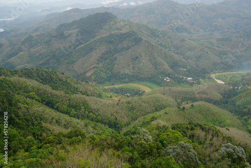 Landscape Green nature fog and misty cover around mountain valley seen from Skywalk Aiyerweng Famous landmark in Betong Yala southern thailand - in the morning - Travel and Sighseeing South east Asia 