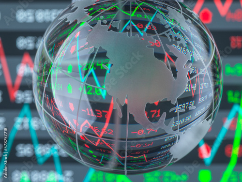 Reflection of financial numbers and graph on glass globe