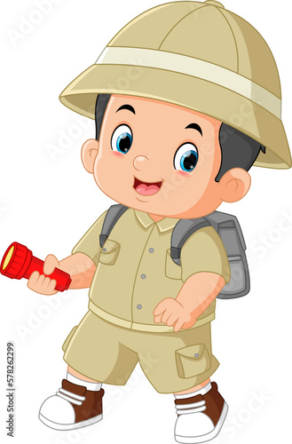 a brave adventurous boy walks and smiles while carrying a flashlight