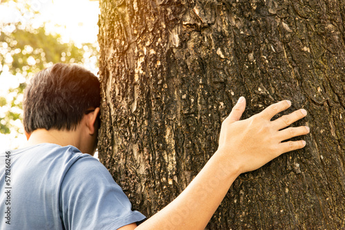 A man huging trunk of tree. Mother Earth day. World environment day, Eco friendly and Sustainability concept