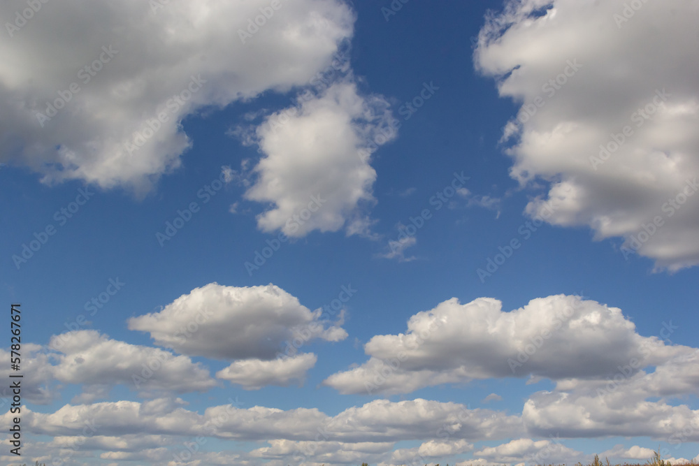 clouds in the sky lit by the sun on a summer day. background clouds in the sky lit by the sun on a summer day. background