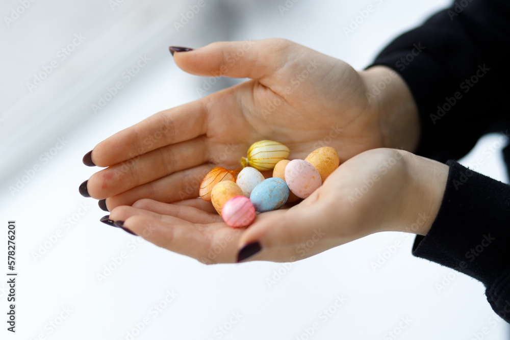Easter toys. Easter toys in the hands of a girl. Blurred background. Easter toys. Easter toys in the hands of a girl. Blurred background.