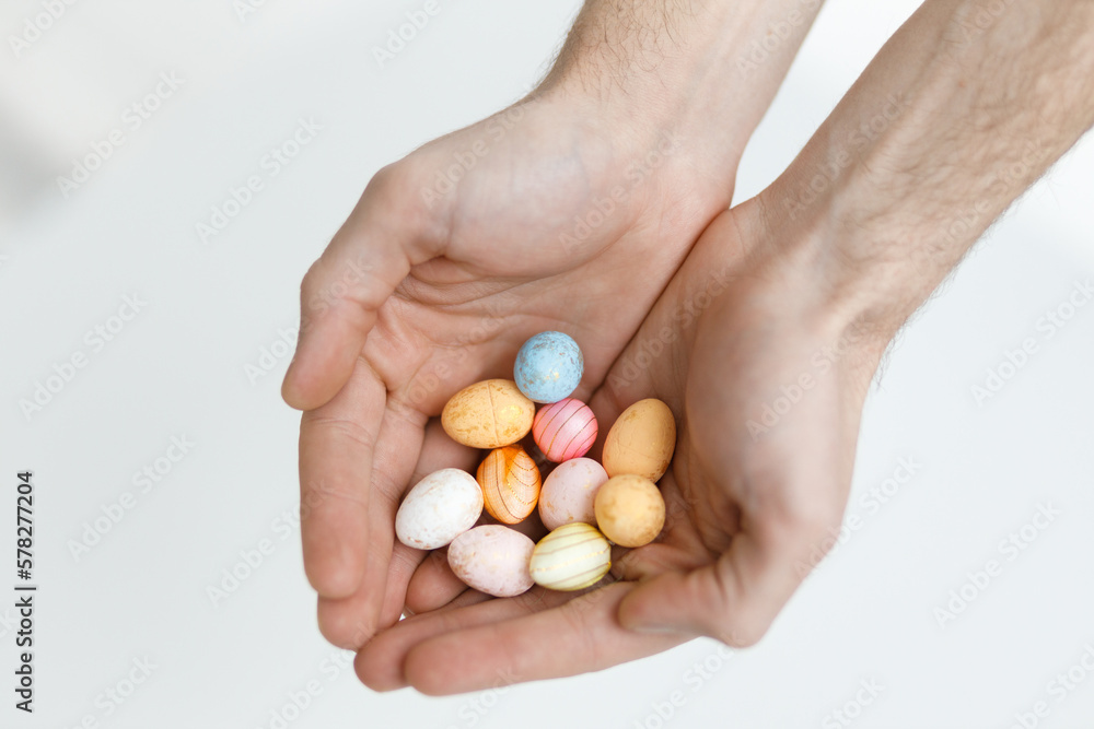 Easter toys. Easter toys in the hands of a man. Blurred background. Easter holiday concept background. Easter toys. Easter toys in the hands of a man. Blurred background. Easter holiday concept background.