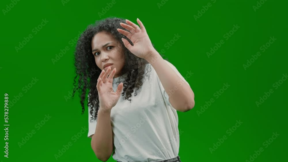 frightened woman with curly long hair dressed white shirt express feel fear or anxiety Isolated on Green Screen frightened woman with curly long hair dressed white shirt express feel fear or anxiety Isolated on Green Screen