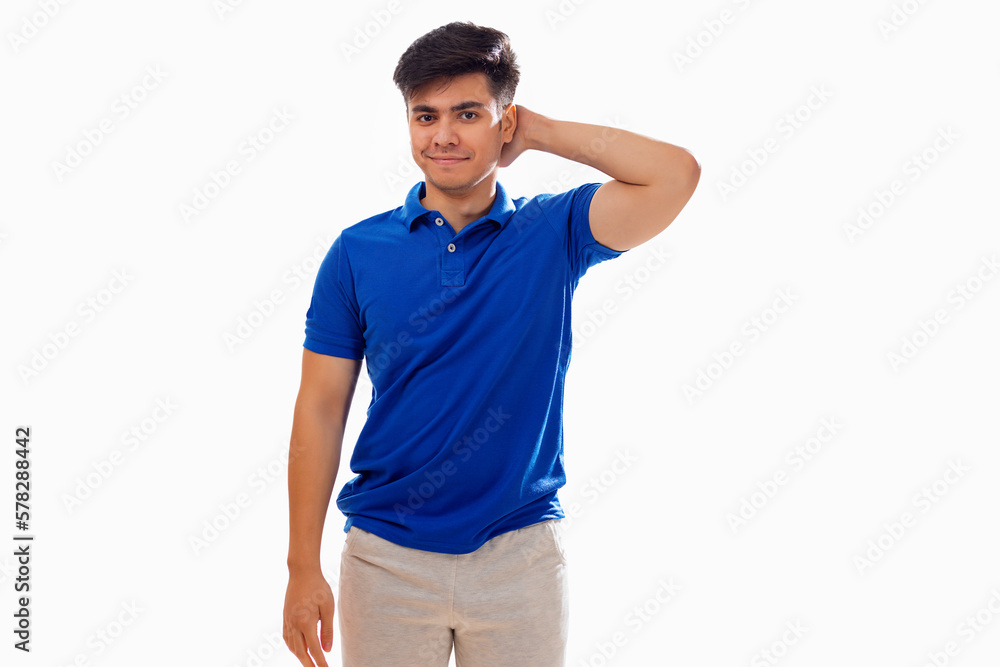 Portrait of young man standing with hand behind head against white background Portrait of young man standing with hand behind head against white background
