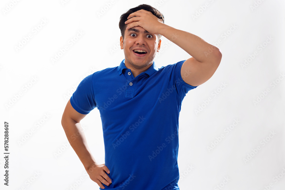 Portrait of surprised young man with hand on head against white background Portrait of surprised young man with hand on head against white background