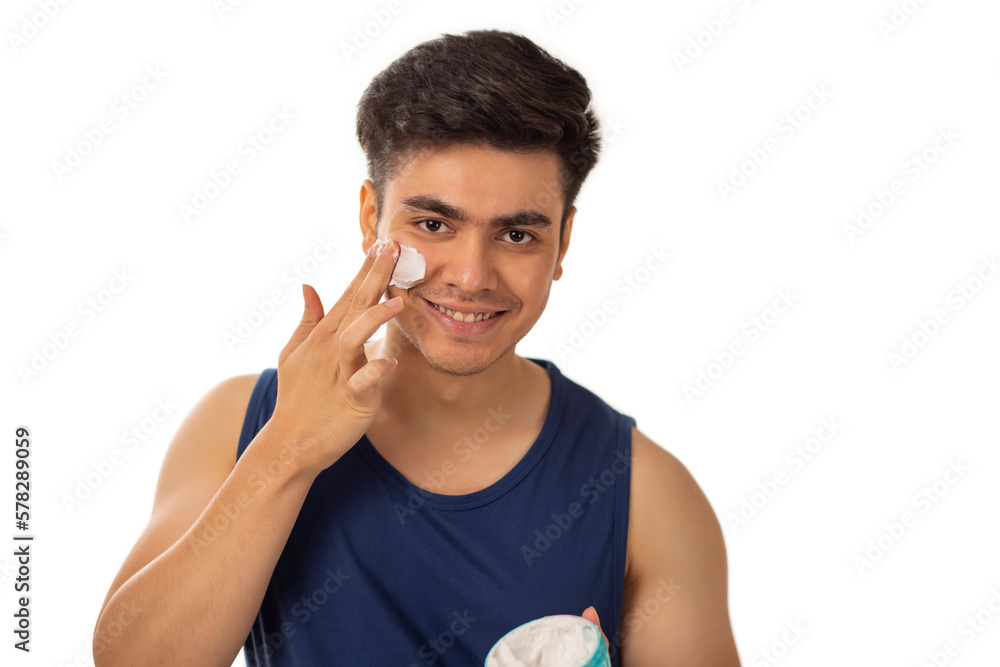 Portrait of cheerful man applying face cream against white background Portrait of cheerful man applying face cream against white background