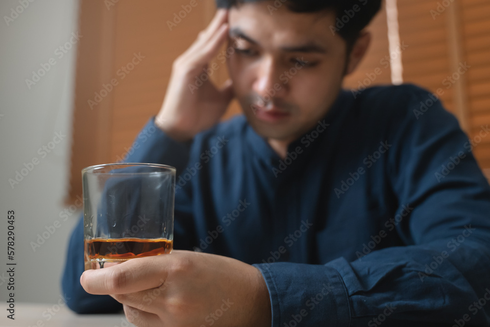 Close up hand man holding a glass of whisky Close up hand man holding a glass of whisky