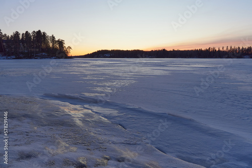 Sunset in winter on Finnish Tuusula lake: view from Halosenniemi.