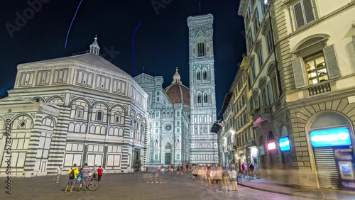 The front of The Basilica di Santa Maria del Fiore and Baptistery San Giovanni night timelapse hyperlapse. Cathedral church (Duomo) of Florence in Italy. Evening illumination. Bell tower and dome photo