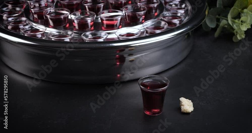 Taking communion concept - the wine and the bread symbols of Jesus Christ blood and body with Holy Bible. Easter Passover and Lord Supper concept. Dolly shot 4k