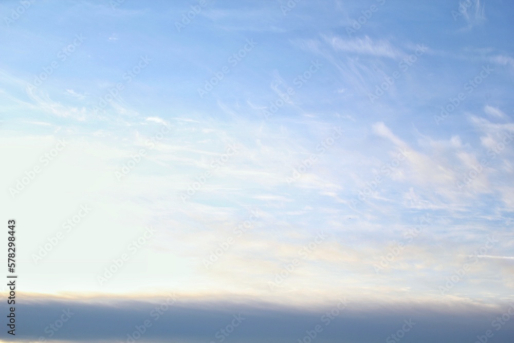 White light soft clouds floating in blue sky. Nature morning landscape background. Clear spring wind. Bright summer day. Winter calm air skyscape. Abstract panorama. Change climate. Low angle view