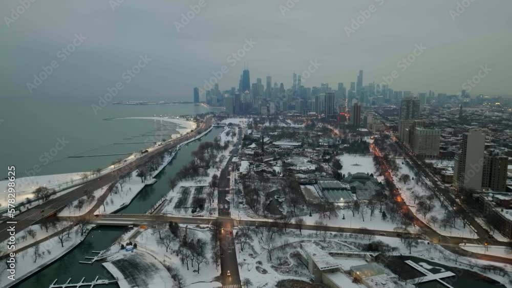 Drone shot rising away from the Lincoln park, misty, winter evening in Chicago, USA - pull back, drone shot Drone shot rising away from the Lincoln park, misty, winter evening in Chicago, USA - pull back, drone shot