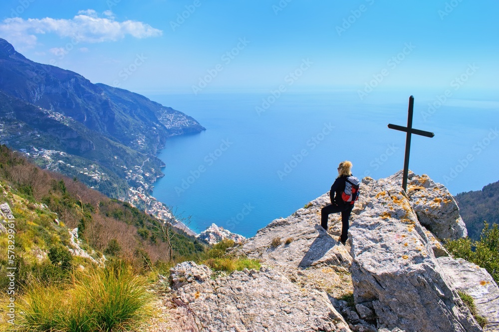 Woman hiker watching beautiful costal scenery - Path of the Gods "Sentiero degli Dei" the famous hiking trail, Amalfi Coast - obrazy, fototapety, plakaty 