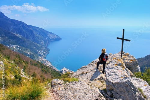 Woman hiker watching beautiful costal scenery - Path of the Gods "Sentiero degli Dei" the famous hiking trail, Amalfi Coast