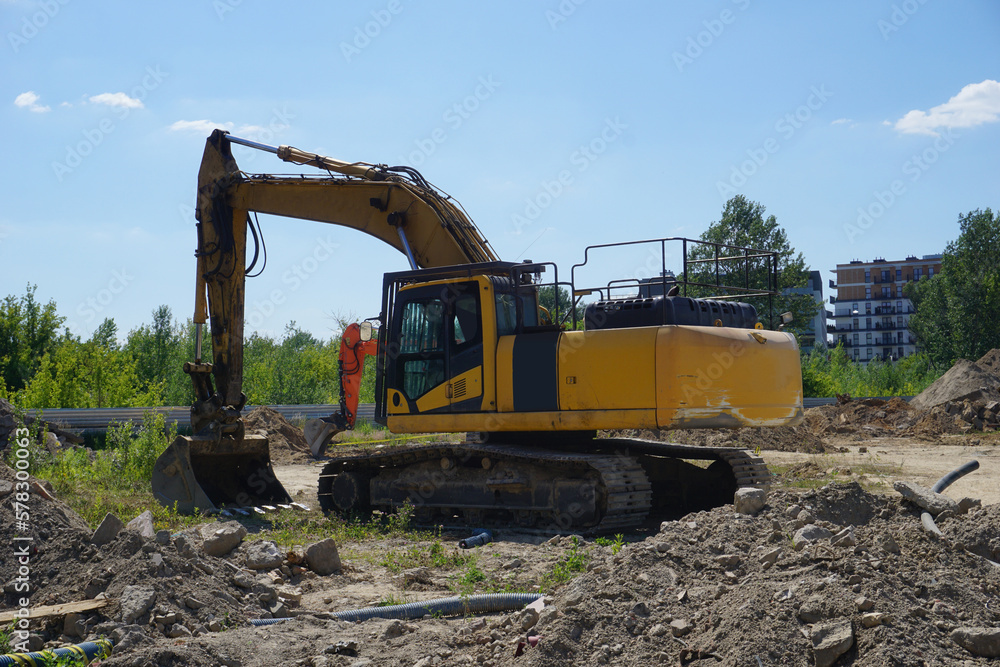 Yellow excavator on construction site Yellow excavator on construction site