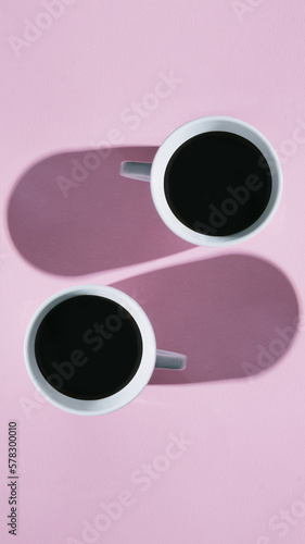 Creative layout with coffee or tea cups on a pink pastel background.Flat lay.