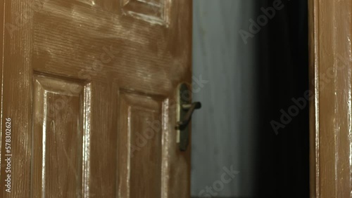 Old door slowly opeing into old dark room