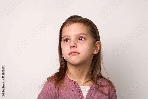 Crying child girl against white background