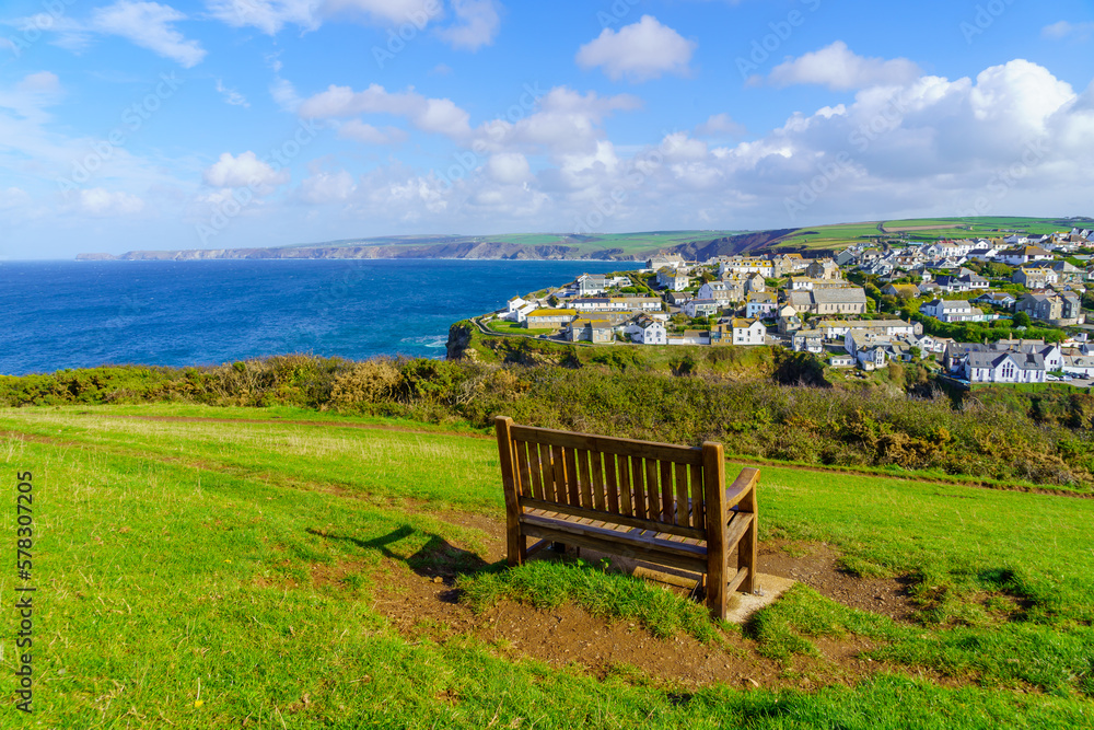Bench, the village, and the coastline, in Port Isaac