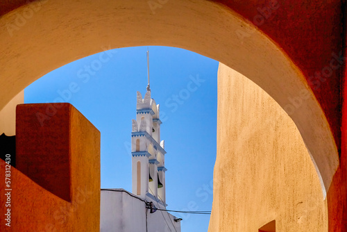 A vertical shot of church bells in Emporio village. Santorini, Greece. Church of Our Lady Messani or Church of Old Panaghia. This church built during the 16th century