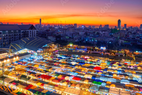 Beautiful sunset over Bangkok, Thailand, and colorful night market. 