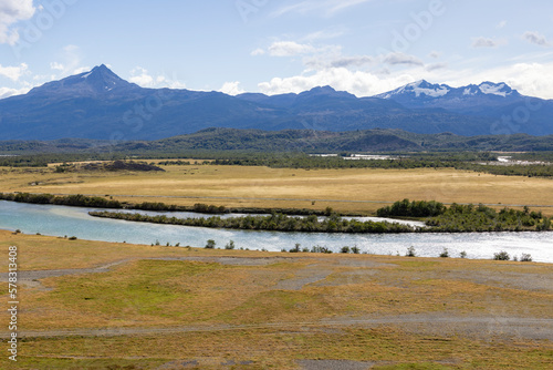 Golden Pampas, River Serrano and snowy mountains of Torres del Paine National Park in Chile, Patagonia, South America